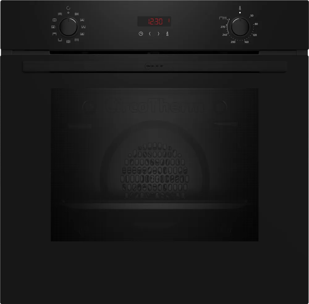 Black oven with digital display and control knobs on a black background