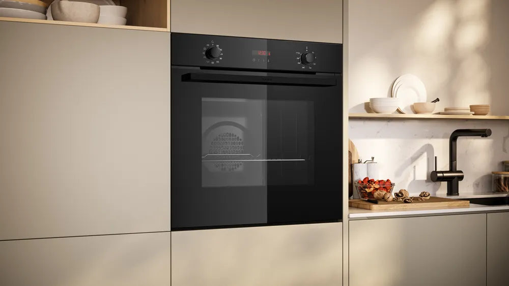 Modern kitchen with a black oven and light-colored cabinets