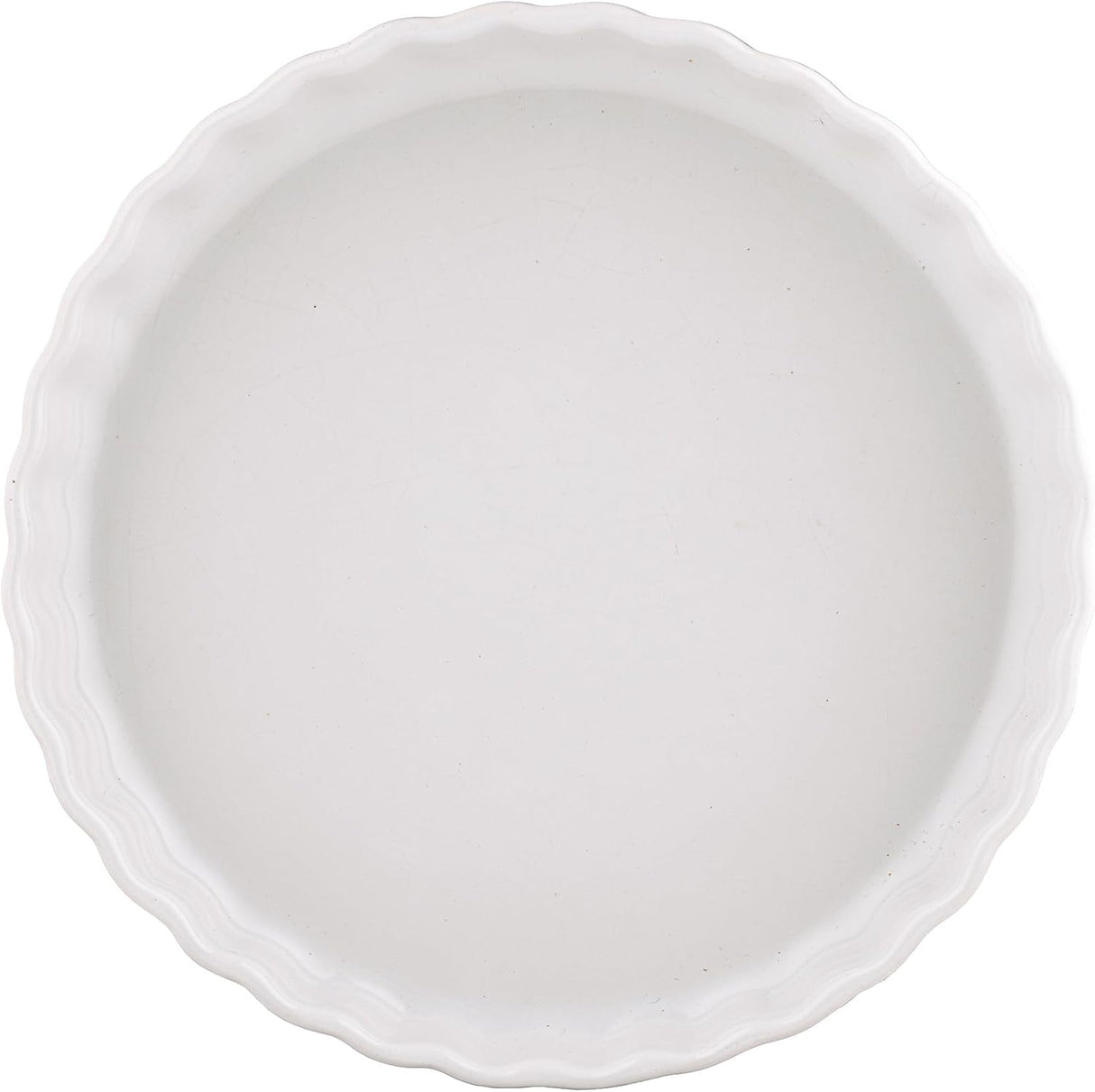 A white ceramic pie or tart dish with a scalloped rim, shown from a top-down view on a white background.