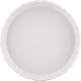 A white ceramic pie or tart dish with a scalloped rim, shown from a top-down view on a white background.